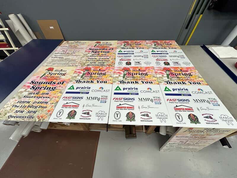 An image of posters lined up on a table.
